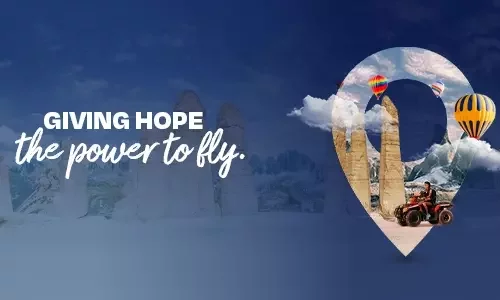 Hot-air balloons floating above valleys and caves in Cappadocia